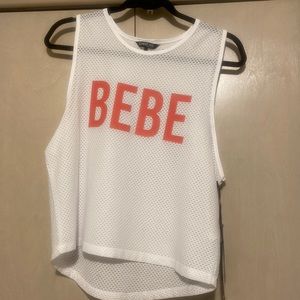 BEBE tank top. White mesh with pink writing